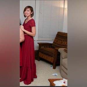 Floor length deep red dress.